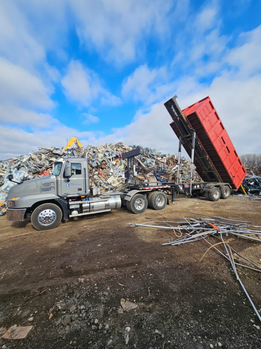 All American Recycling Truck Dumping Scrap Metal.